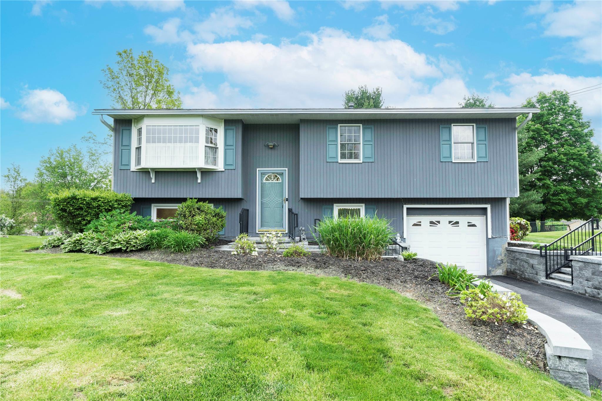 a front view of a house with garden