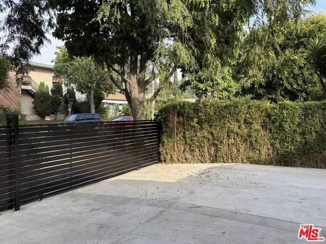 a view of wooden fence and trees