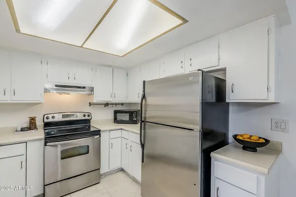 a kitchen with cabinets and stainless steel appliances