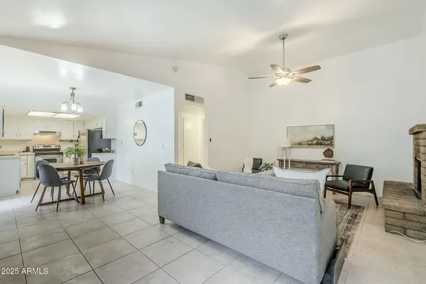 a living room with furniture and a dining table