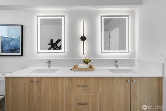 a bathroom with a granite countertop sink and a mirror