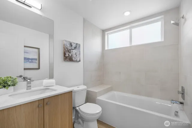 a bath room with a toilet a sink and a bath tub