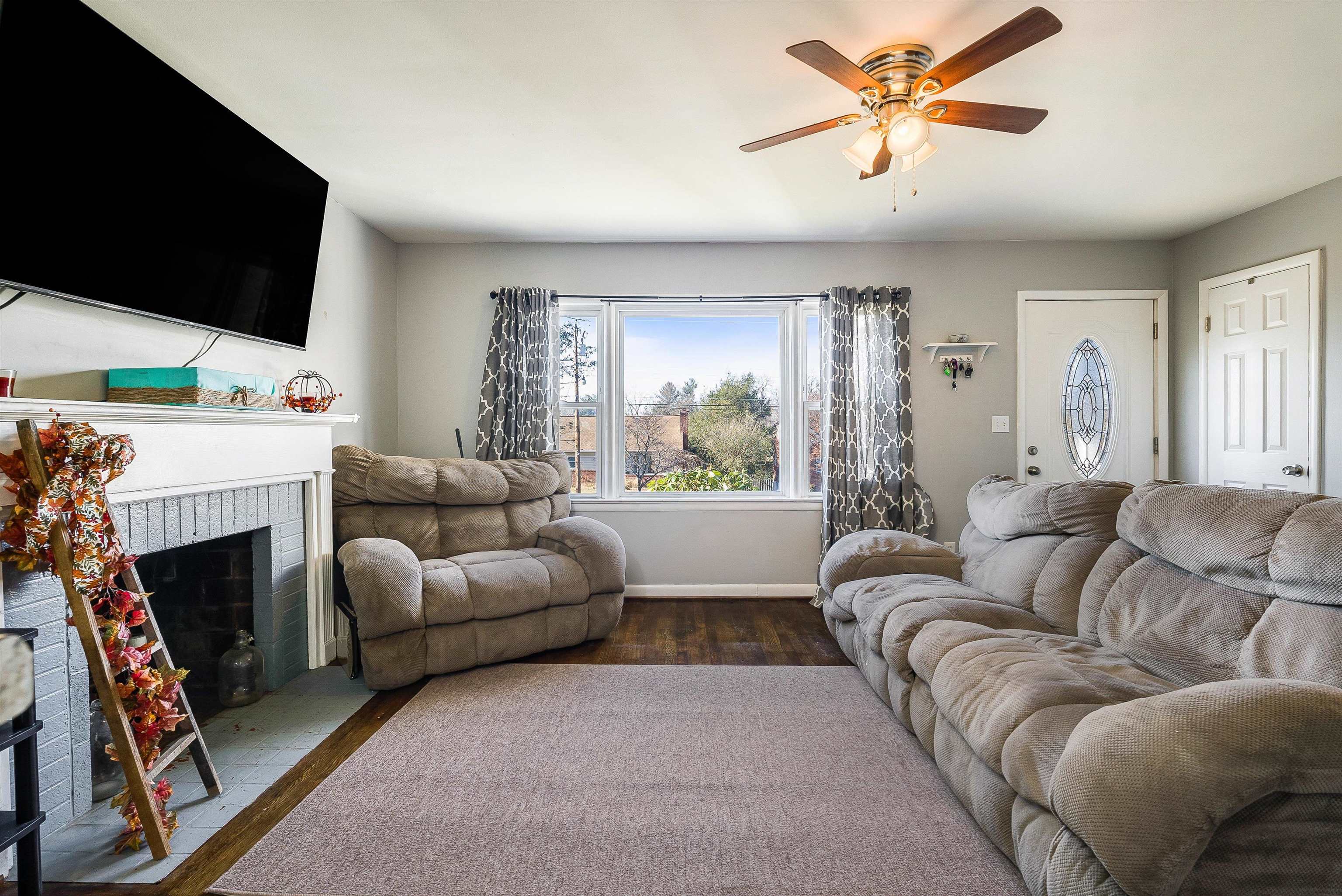 812 Florence Avenue Waynesboro, VA 22980 - Photo 4 of 24 a living room with furniture a fireplace and a flat screen tv