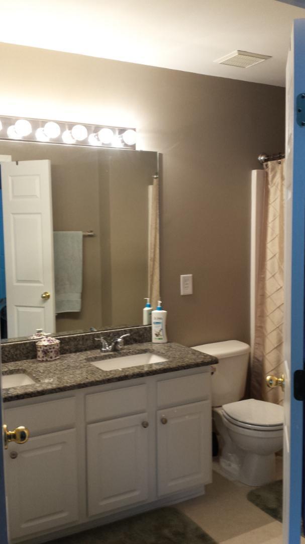 8521 Silhouette Place Raleigh, NC 27613 - Photo 13 of 20 a bathroom with a granite countertop sink a toilet and a mirror