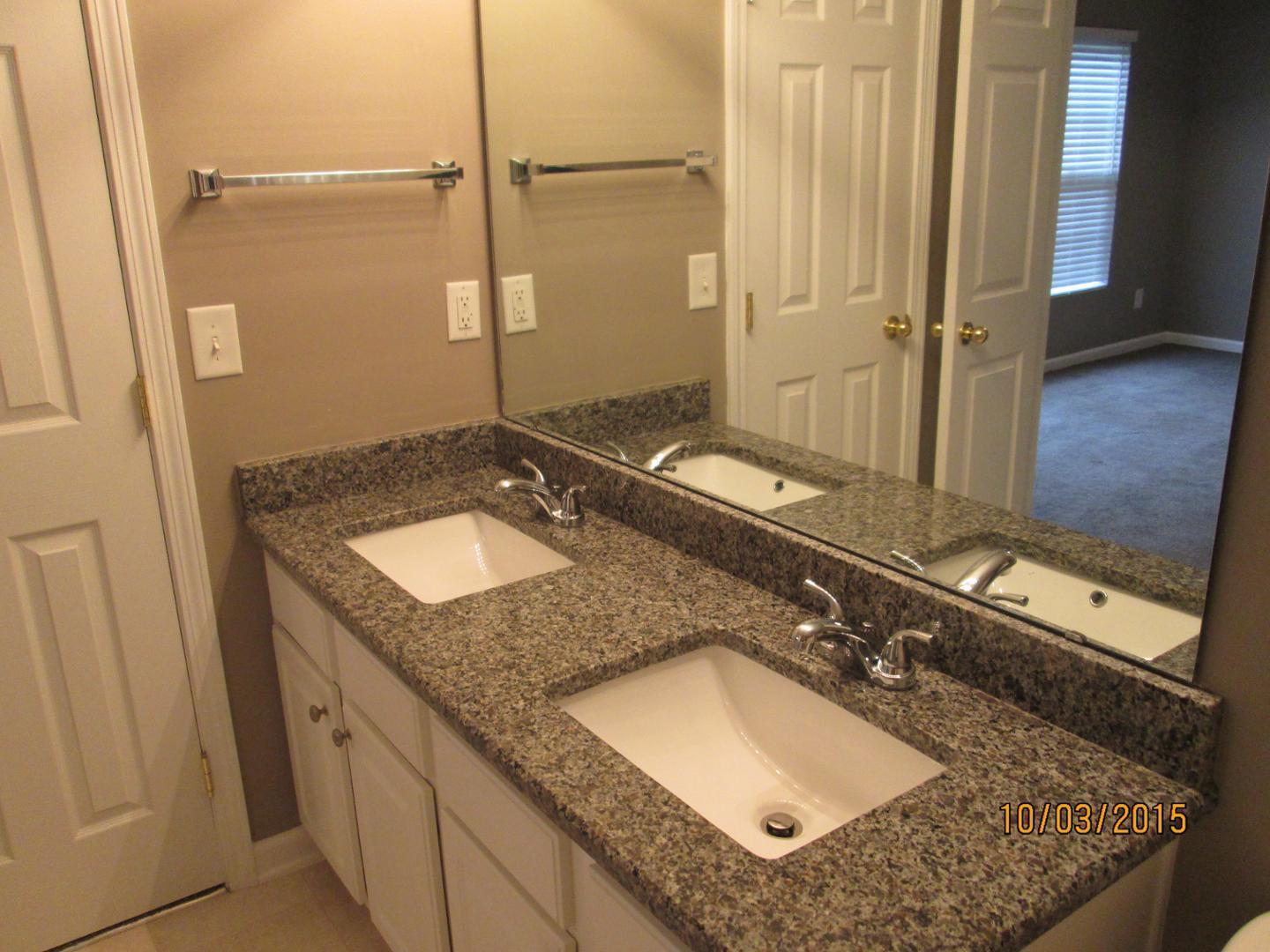 8521 Silhouette Place Raleigh, NC 27613 - Photo 14 of 20 a bathroom with a granite countertop sink and a mirror