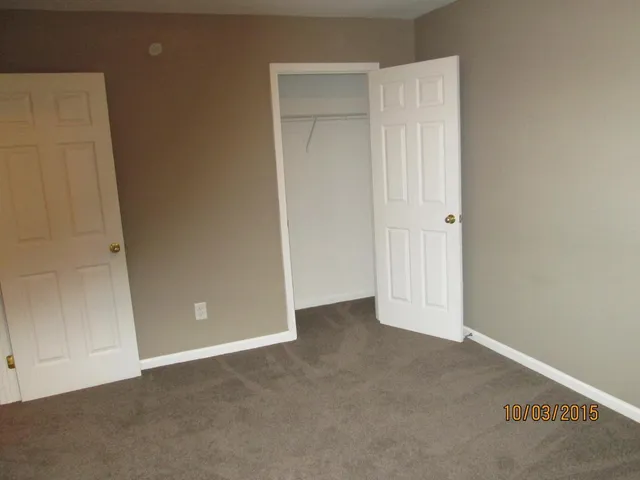an empty room with closet area