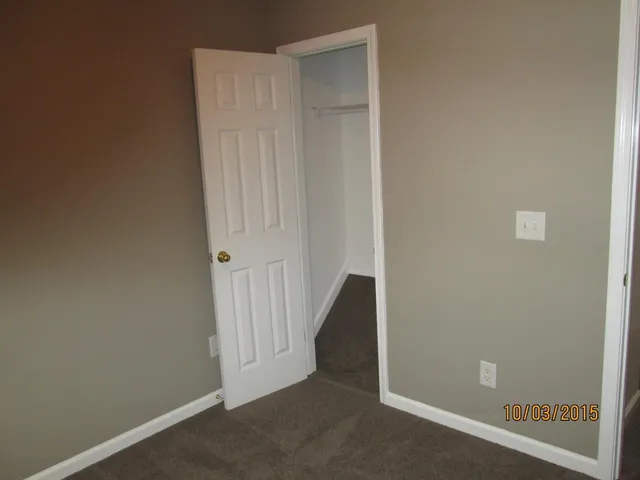 a bathroom with a granite countertop toilet sink and mirror