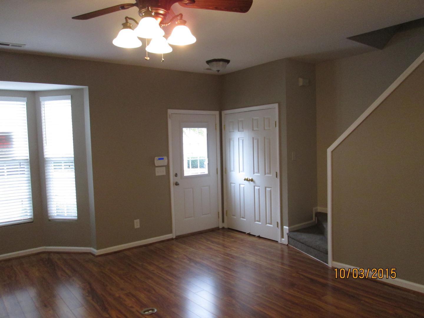 8521 Silhouette Place Raleigh, NC 27613 - Photo 2 of 20 a view of an empty room with wooden floor and a window