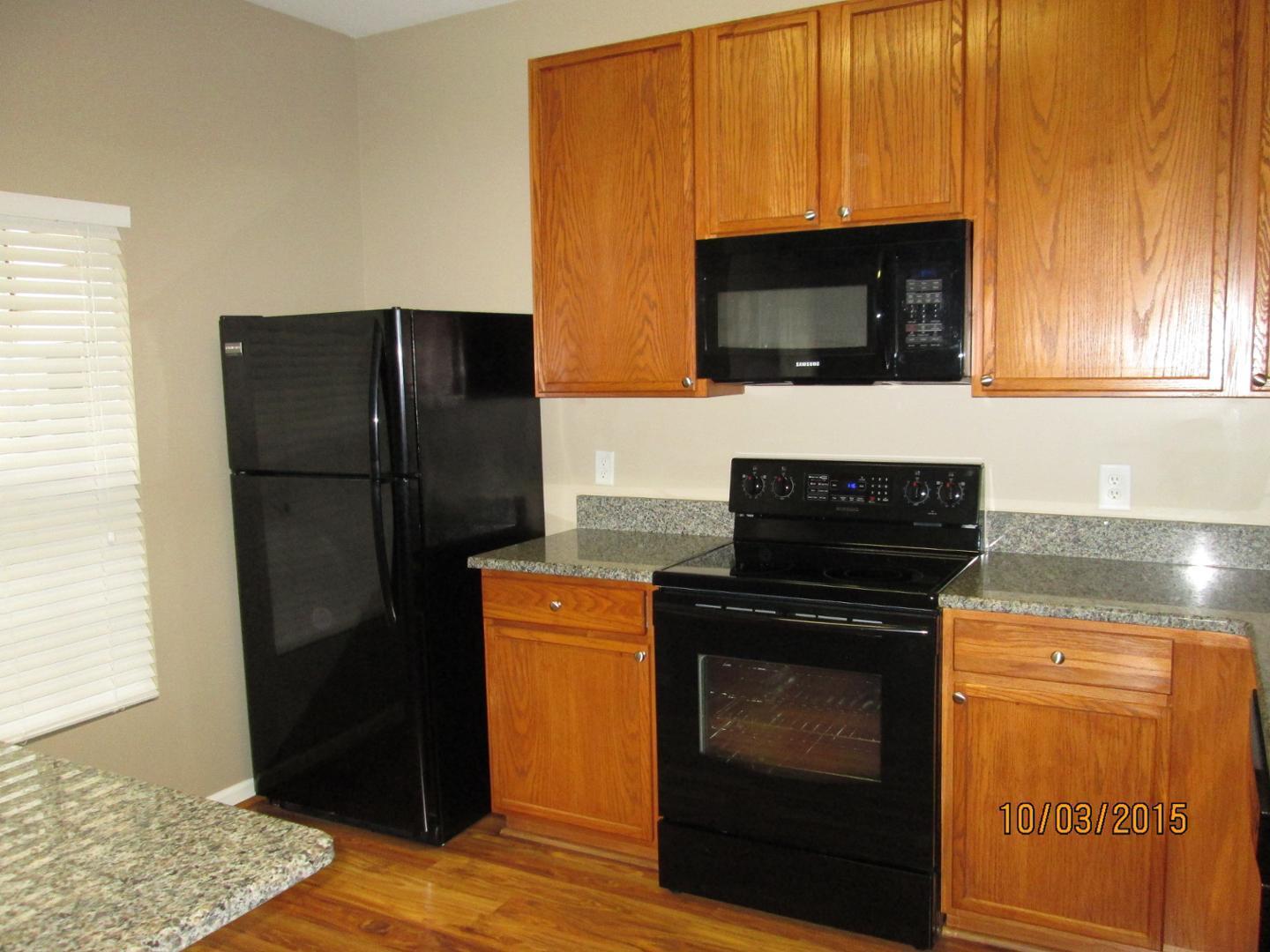 8521 Silhouette Place Raleigh, NC 27613 - Photo 7 of 20 a kitchen with stainless steel appliances wooden cabinets and a stove top oven