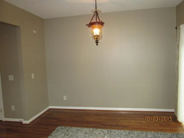 a view of a room with wooden floor and white walls