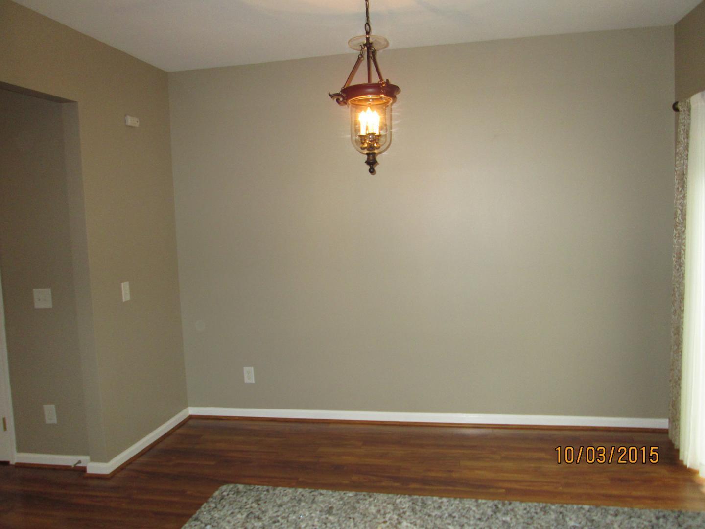 8521 Silhouette Place Raleigh, NC 27613 - Photo 8 of 20 a view of a room with wooden floor and white walls
