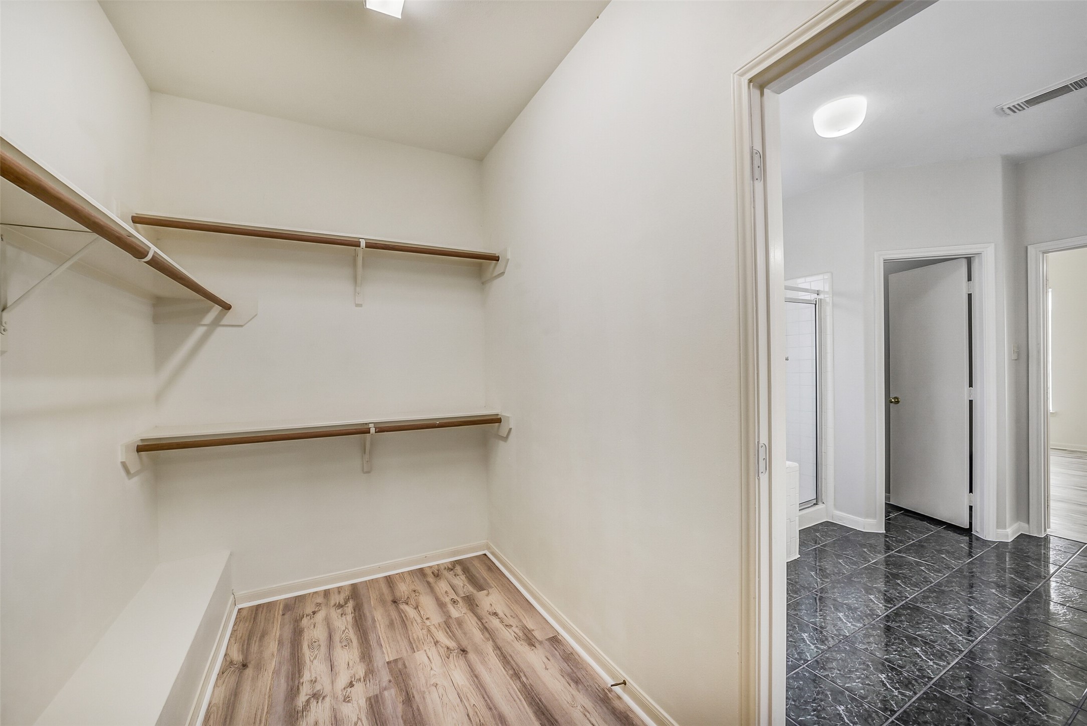 3502 Sweetspire Road Katy, TX 77449 - Photo 19 of 30 A walk-in closet in the primary bedroom offers both luxury and practicality. It features built-in shelving, hanging rods, and drawers designed to maximize storage for clothing, shoes, and accessories