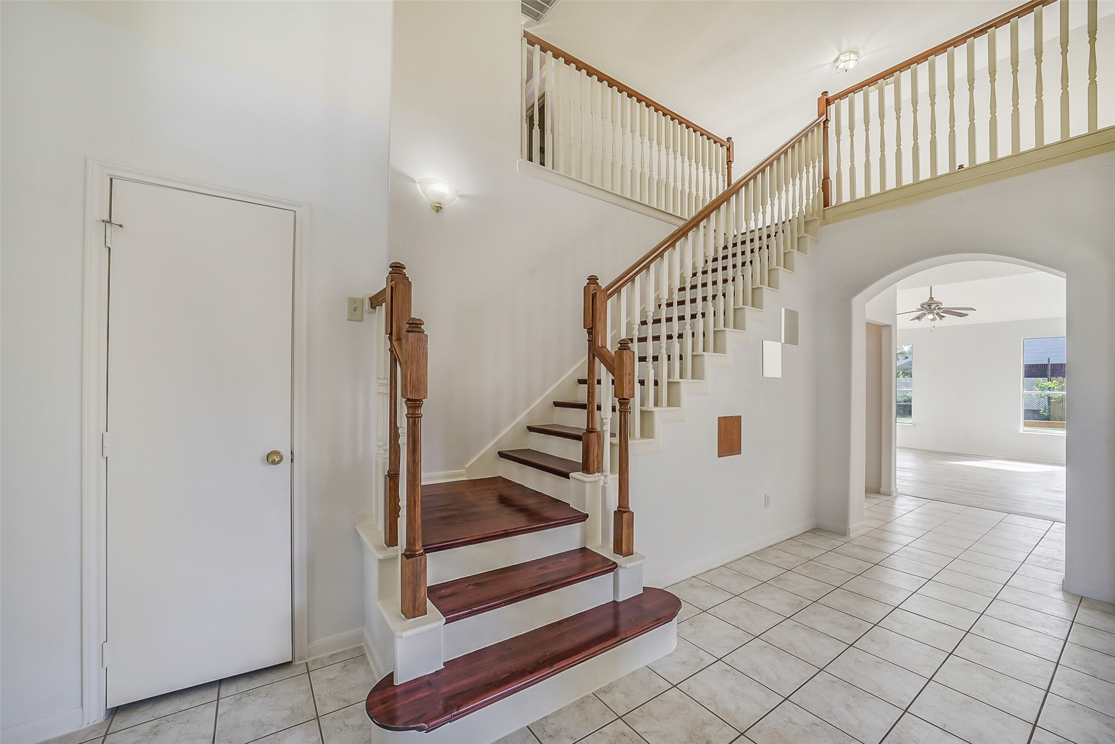 3502 Sweetspire Road Katy, TX 77449 - Photo 20 of 30 The engineered-wood stairway leading to the second floor features a stylish landing that opens to the space below, creating a bright, airy sense of openness. Its warm wood tones and smooth finish add a touch of elegance, while the overlook enhances the home’s spacious, connected feel.