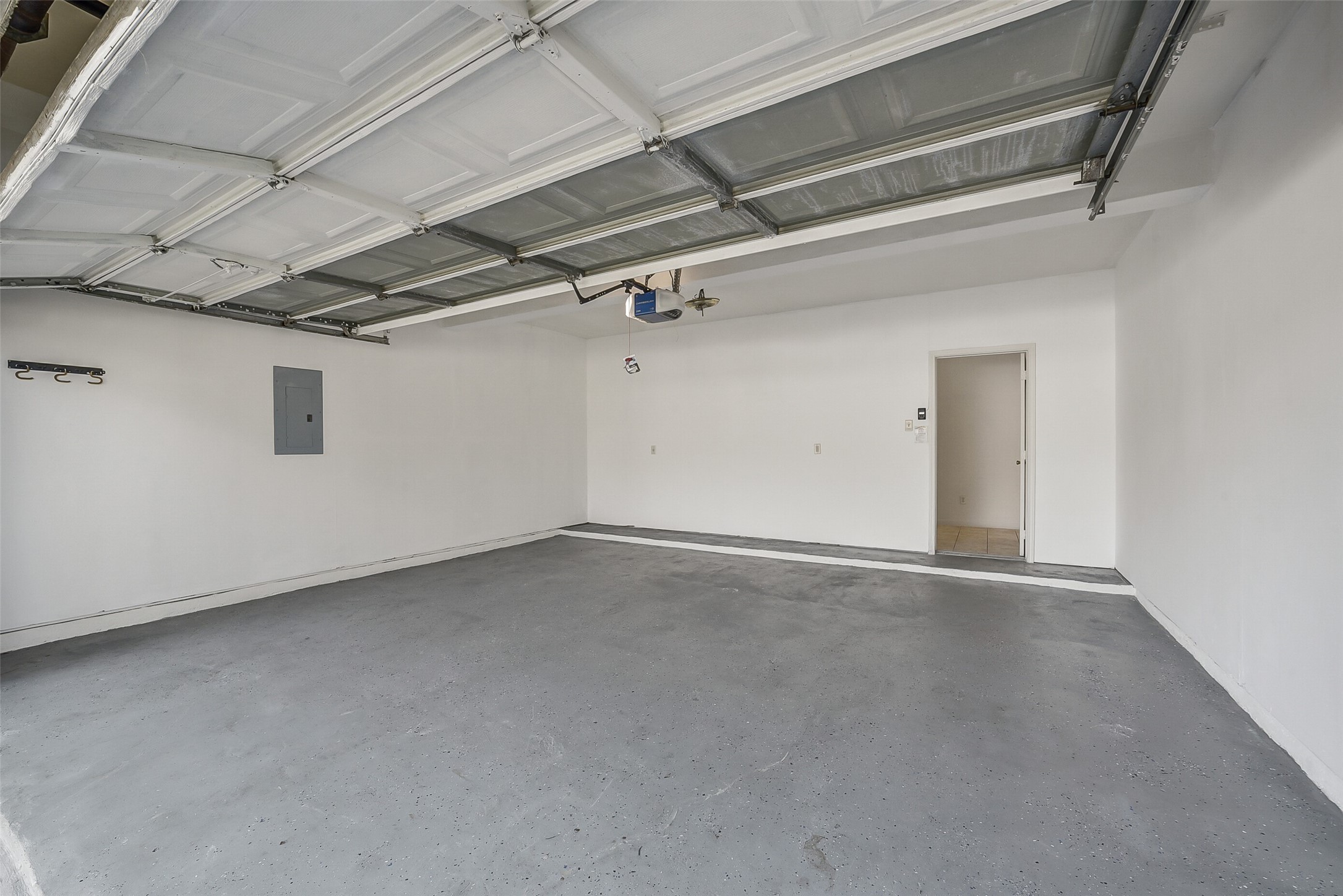 3502 Sweetspire Road Katy, TX 77449 - Photo 27 of 30 The well-kept two-car garage features updated flooring designed to withstand the Texas weather, providing a clean, durable, and low-maintenance space for vehicles and storage. Its tidy condition and upgraded finish make it both functional and appealing for everyday use.