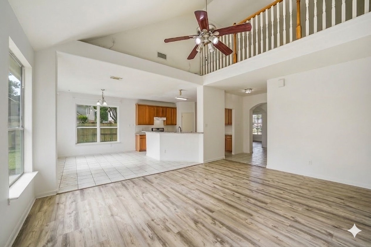 3502 Sweetspire Road Katy, TX 77449 - Photo 7 of 30 A spacious family room designed for comfort and everyday living, featuring an open layout seamlessly connected to the kitchen—perfect for entertaining and family gatherings. Expansive windows fill the space with natural light while offering beautiful views of the backyard, creating a bright and inviting atmosphere. The room’s open sightlines enhance the sense of space, making it ideal for both relaxing evenings and lively social occasions.