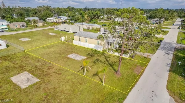 a view of a swimming pool with lawn chairs and wooden floor