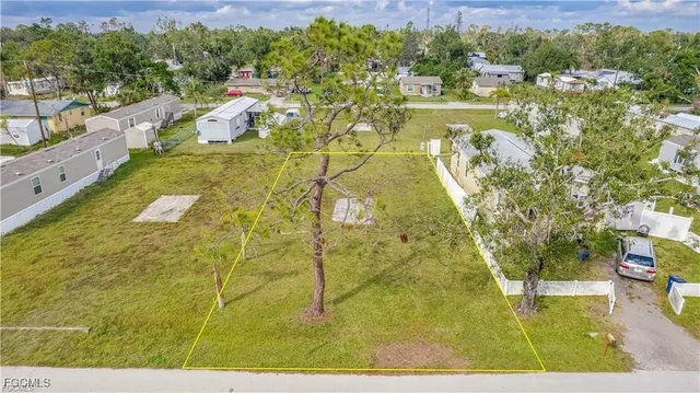 a view of swimming pool with seating area and trees in the background