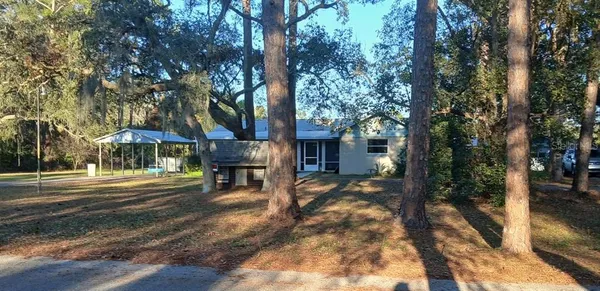 a view of a house with backyard and sitting area