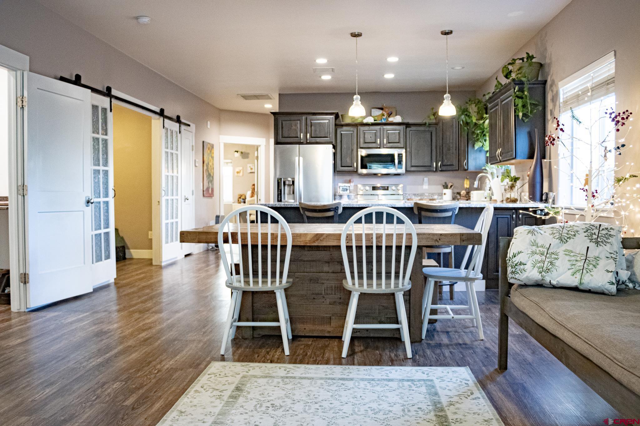 210 West 3rd Street, Unit 4 Cortez, CO 81321 - Photo 3 of 35 a view of a dining room with furniture window and wooden floor