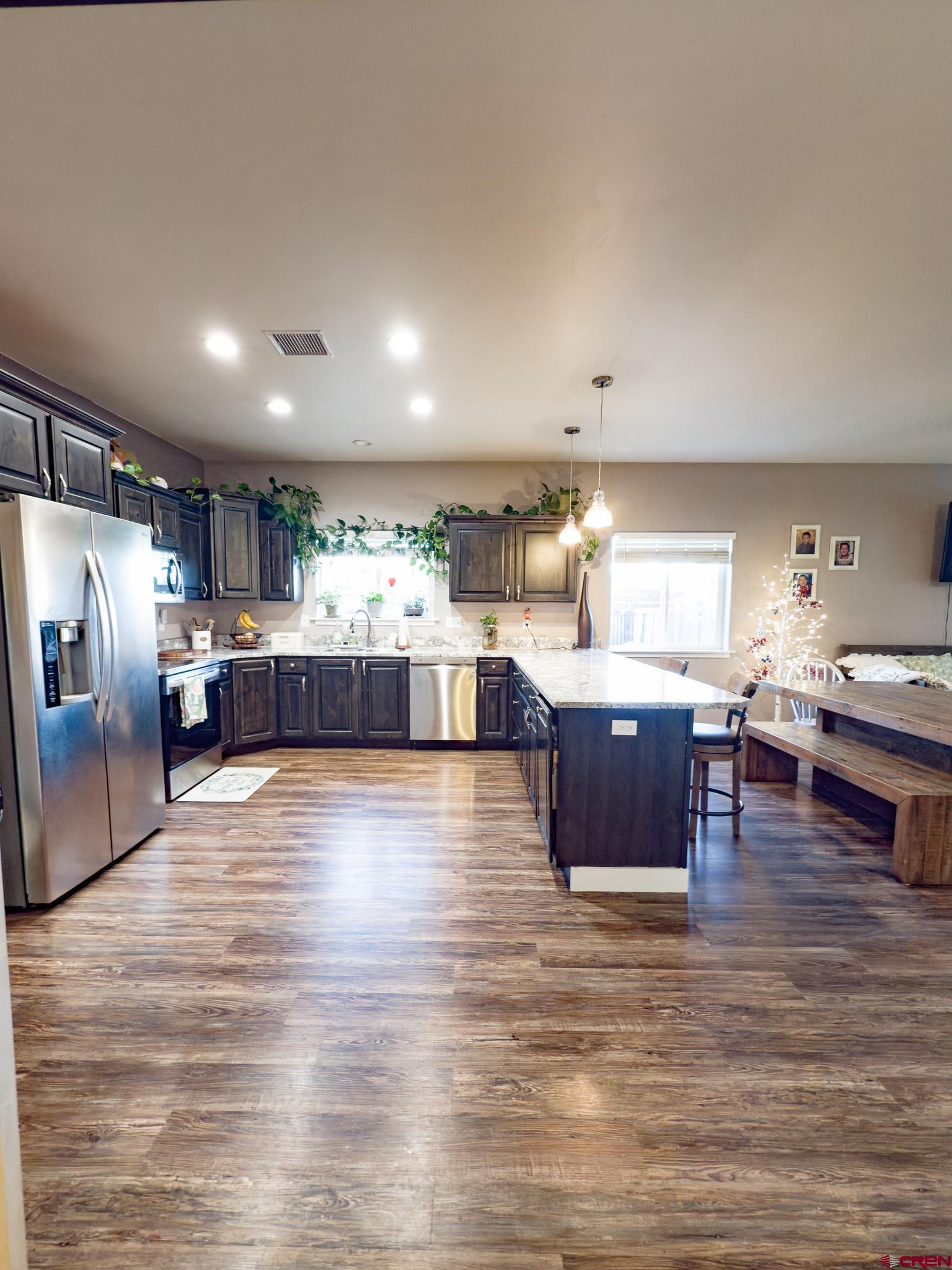 210 West 3rd Street, Unit 4 Cortez, CO 81321 - Photo 6 of 35 a room with stainless steel appliances kitchen island granite countertop a large counter top couches and cabinets