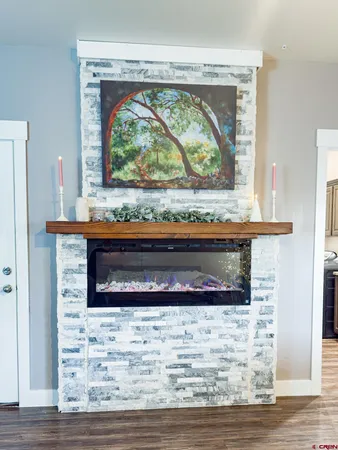 a living room with a fireplace and a wooden floor