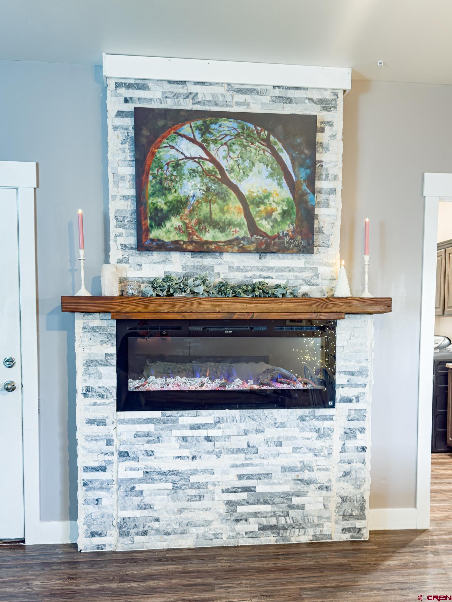 210 West 3rd Street, Unit 4 Cortez, CO 81321 - Photo 8 of 35 a living room with a fireplace and a wooden floor