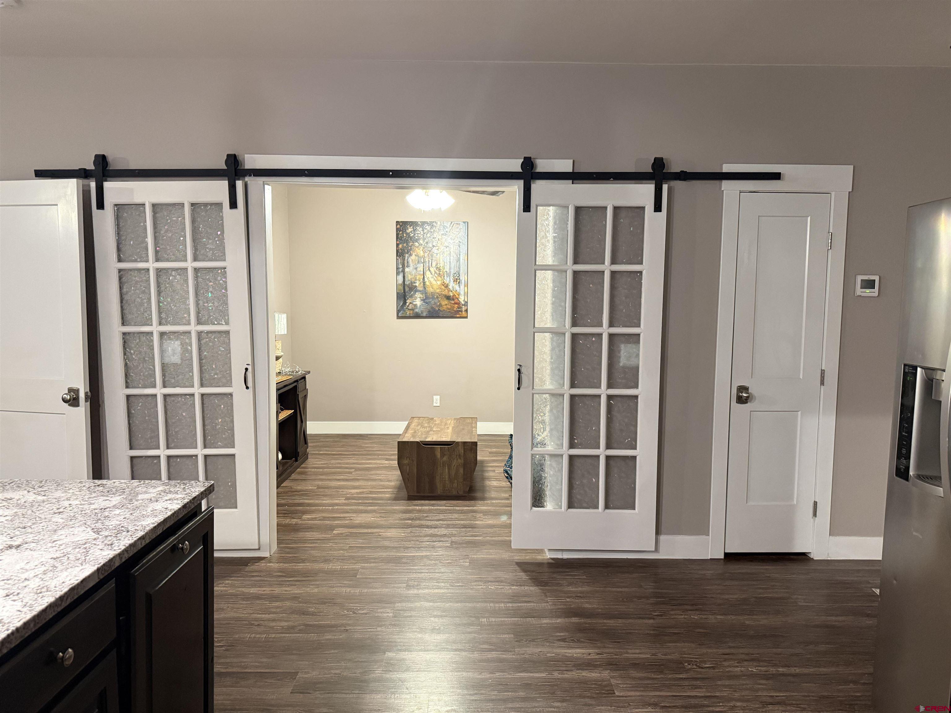 210 West 3rd Street, Unit 4 Cortez, CO 81321 - Photo 10 of 35 an empty room with wooden floor and windows