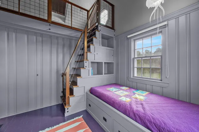 a bedroom with a bed and a window