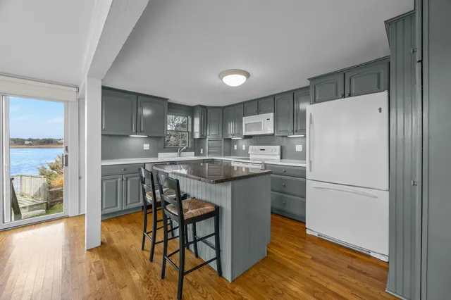 a kitchen with a refrigerator a sink and a stove top oven