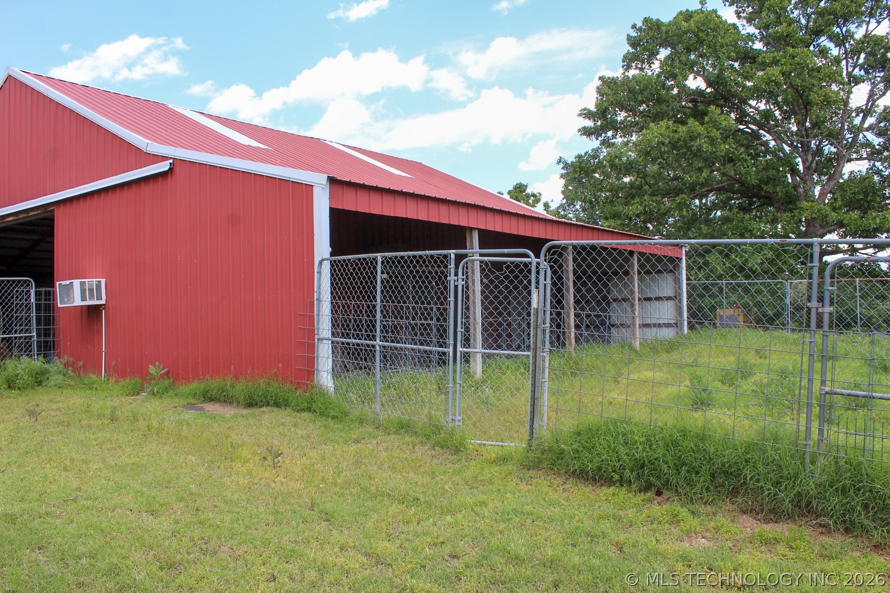13248 North 3540th Road Maud, OK 74854 - Photo 93 of 98 Red metal barn with a red metal roof and white trim