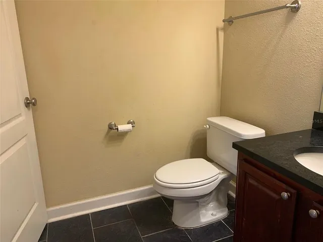 a white toilet sitting next to a shower