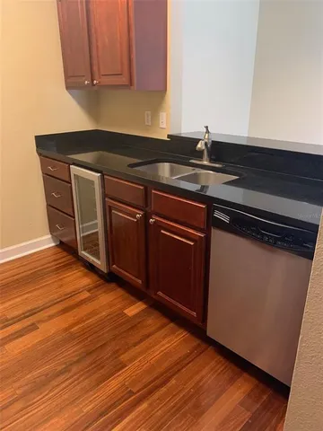 a kitchen with granite countertop wooden cabinets and a sink