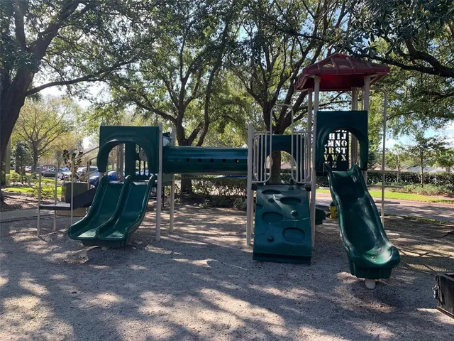 a view of a park with iron fence