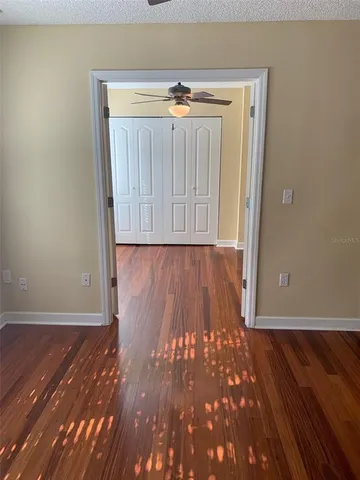 an empty room with wooden floor and a window