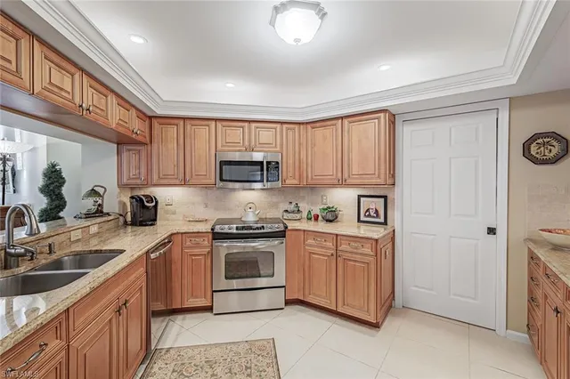 a kitchen with stainless steel appliances granite countertop a stove a sink dishwasher and a refrigerator