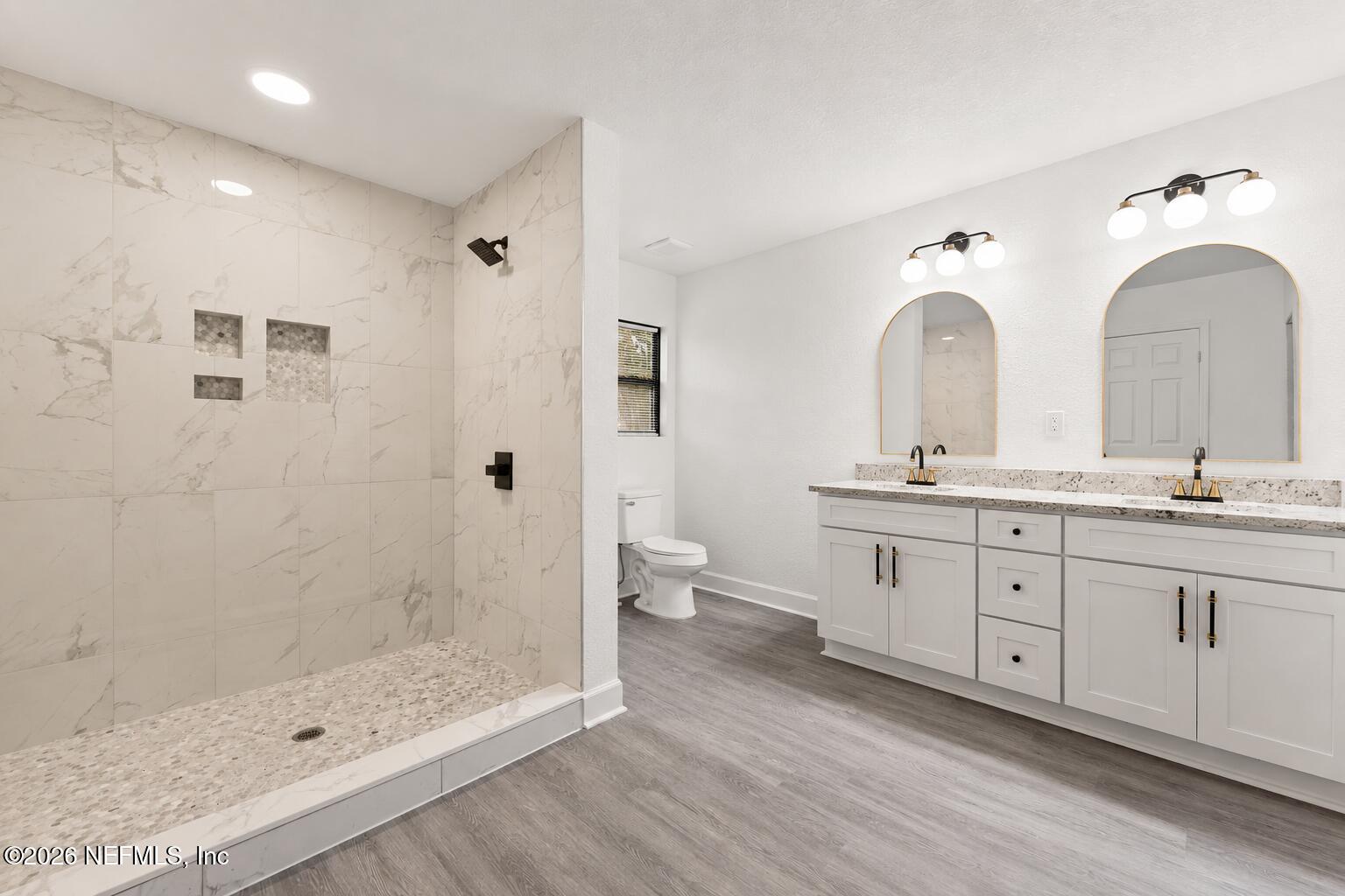 2131 Redfern Road Jacksonville, FL 32207 - Photo 10 of 13 a en suite bathroom with double sink a toilet a shower and a window