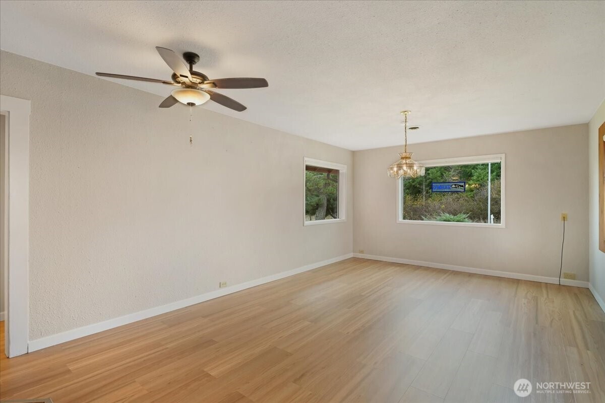 283 Sargent Road Winlock, WA 98596 - Photo 6 of 39 a view of an empty room with wooden floor and a window