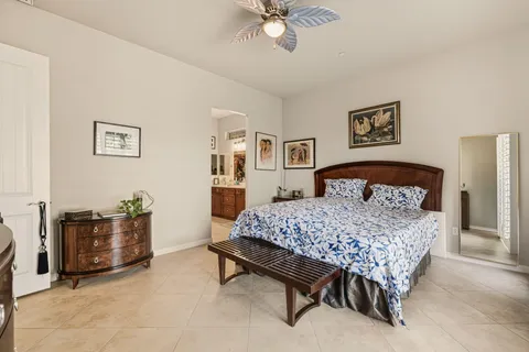 a bedroom with a bed and ceiling fan