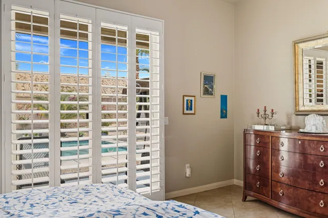 a view of a bedroom with wooden floor and windows