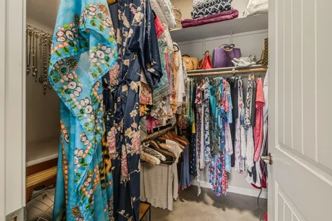 a view of walk in closet with clothes