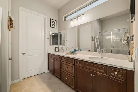 a spacious bathroom with a double vanity sink mirror and double