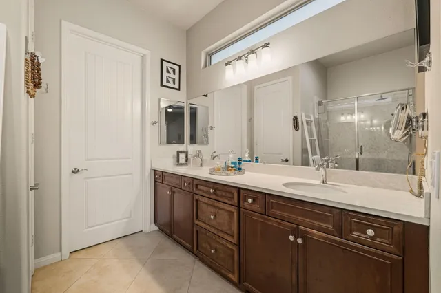 a spacious bathroom with a double vanity sink mirror and double
