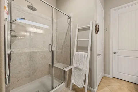a bathroom with a glass shower door