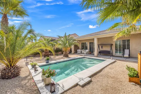 a view of a house with backyard porch and sitting area