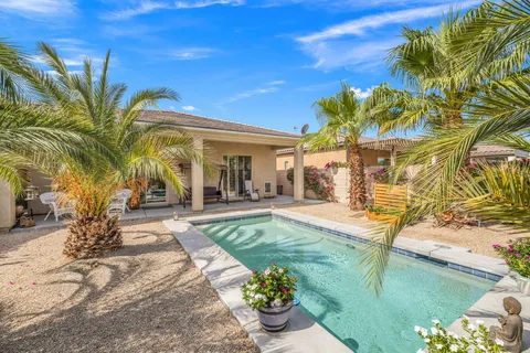 a view of a backyard with plants and patio