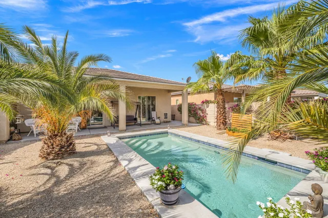 a view of a backyard with plants and patio