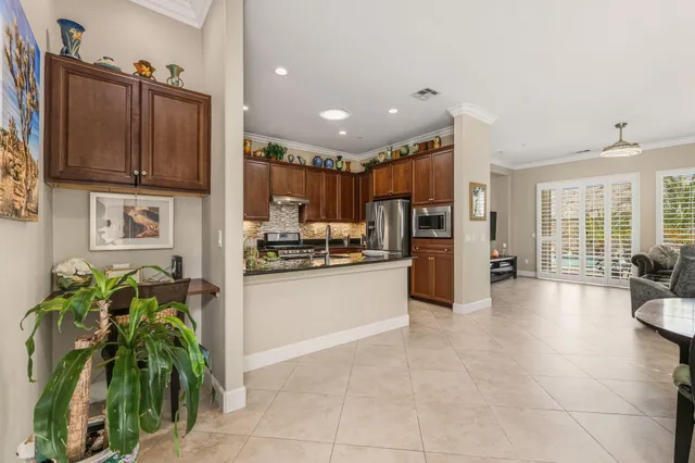 a kitchen with stainless steel appliances a refrigerator a sink a stove and cabinets