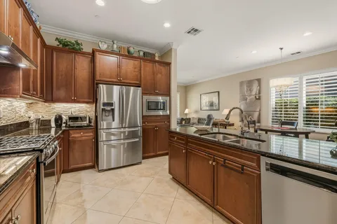 a kitchen with a sink stainless steel appliances and cabinets