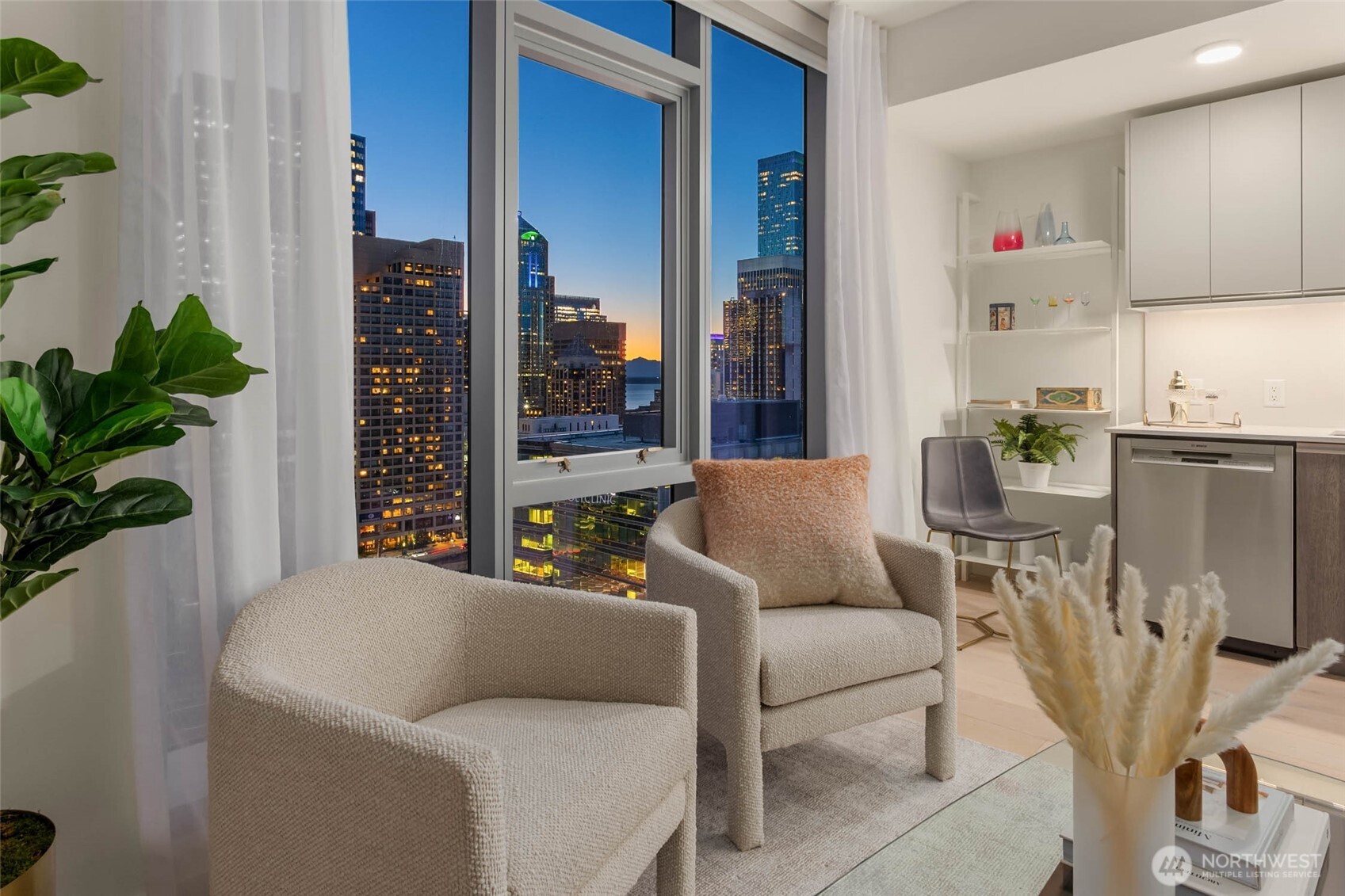 800 Columbia Street, Unit 1109 Seattle, WA 98104 - Photo 11 of 40 a living room with furniture and a potted plant