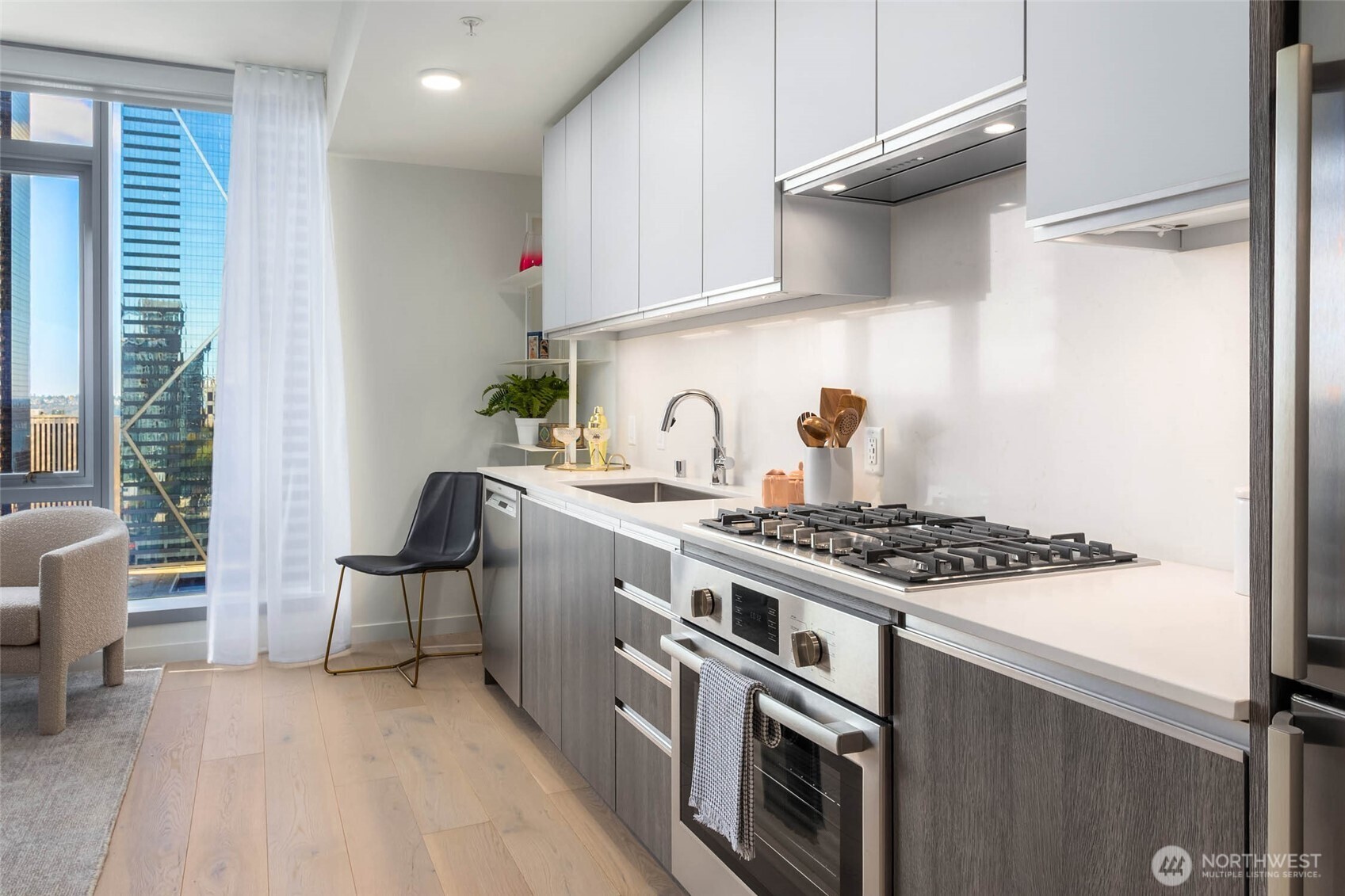 800 Columbia Street, Unit 1109 Seattle, WA 98104 - Photo 5 of 40 a kitchen with stainless steel appliances granite countertop a stove and a refrigerator